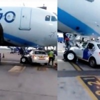 Car stops under parked IndiGo aircraft at Delhi airport