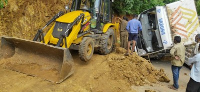 Andhra Police uses JCB to scrape hillside to deblock roadway Andhra Police uses JCB to scrape hillside to deblock roadway