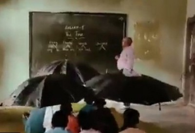 MP: Children study with umbrellas in class MP: Children study with umbrellas in class