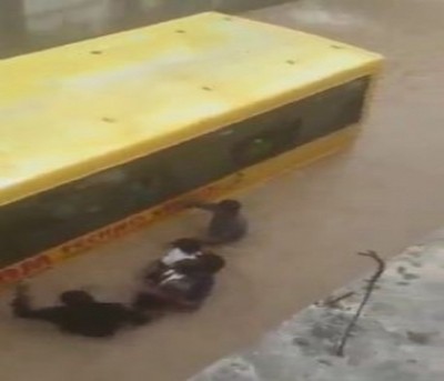 Telangana schoolchildren rescued after bus trapped in flood water Telangana schoolchildren rescued after bus trapped in flood water