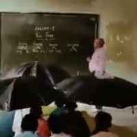 MP: Children study with umbrellas in class