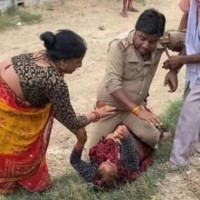 Police official accused of sitting on top of woman, hitting her
