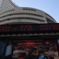 Sensex, Nifty turn flat after touching new highs
