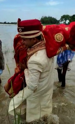 Bihar groom carries bride on shoulder across river Bihar groom carries bride on shoulder across river