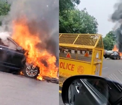 Delhi: Car rams into divider, catches fire Delhi: Car rams into divider, catches fire