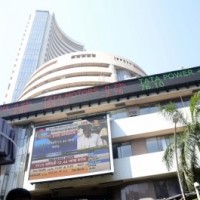 Equity indices settle marginally low amid volatile trade