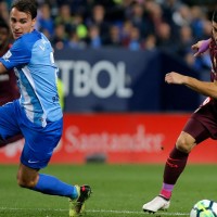 Without Messi, Barcelona stroll past Malaga